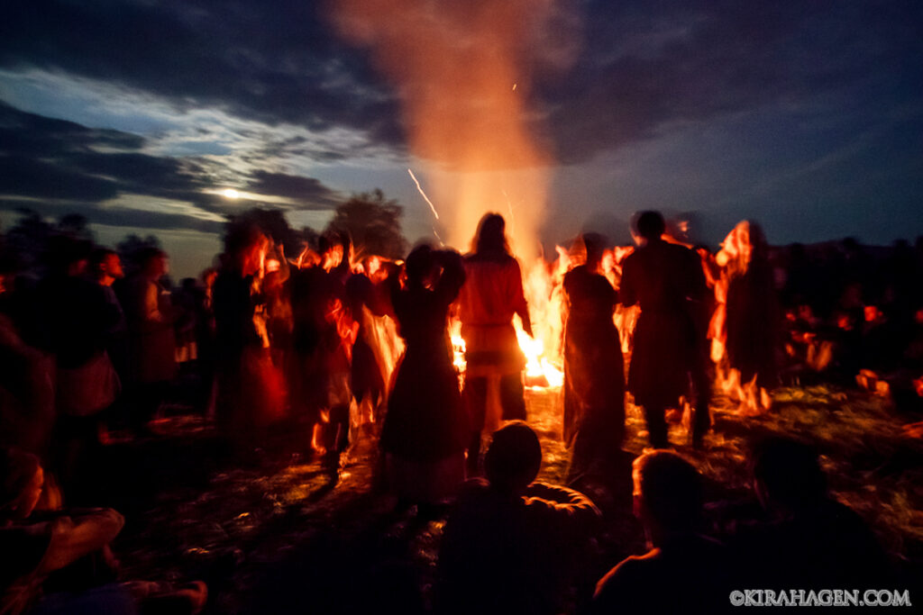 Norse and Slavic reenactors gather around a bonfire
