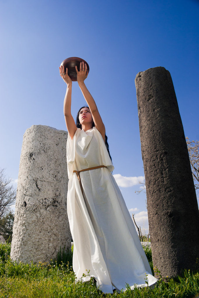 Model Ozge Can (ozgecan.com) poses in a chiton, ancient garb similar to that worn by Greek, Roman, and Celtic peoples in what is now modern Turkey, making an offering to the ancient gods