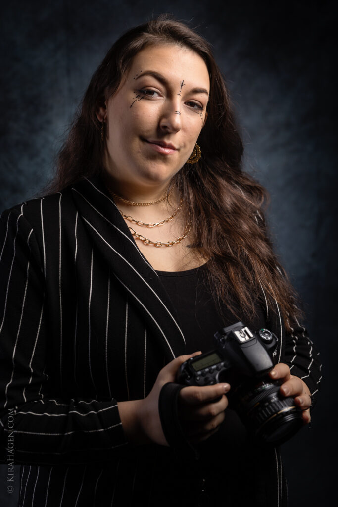 Web-ready edited image of a young woman with a camera